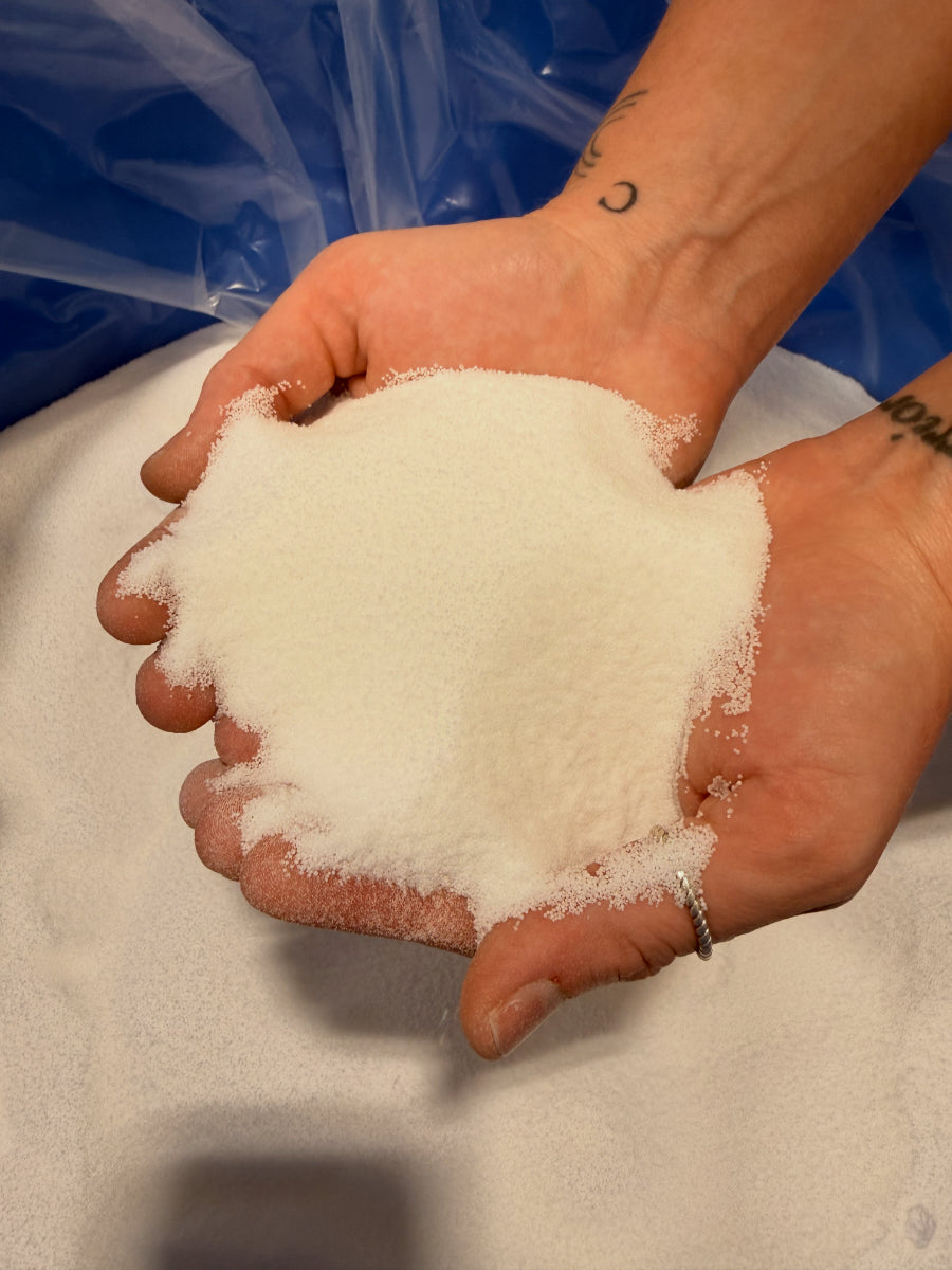 Hands holding abrasive material